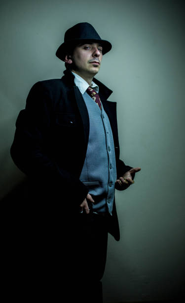 istock Serious detective holding wristwatch 672551960