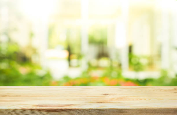 istock Wood table top on blur abstract green from garden background. 672555544