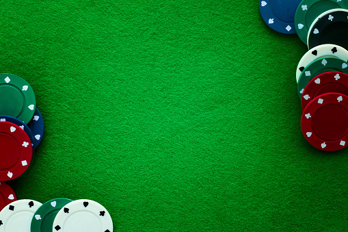 Green felt and playing chips abstract background. Poker, casino and gambling theme