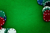istock Green felt and playing chips abstract background. 672556284