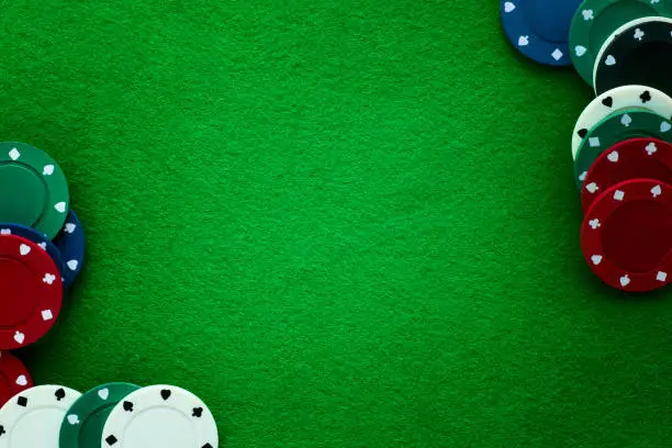 Photo of Green felt and playing chips abstract background.