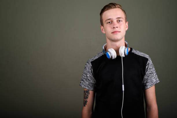 Teenager with headphones listening to music and playing games at the same time .