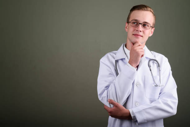 istock Studio shot of young handsome man doctor against colored background 672563134
