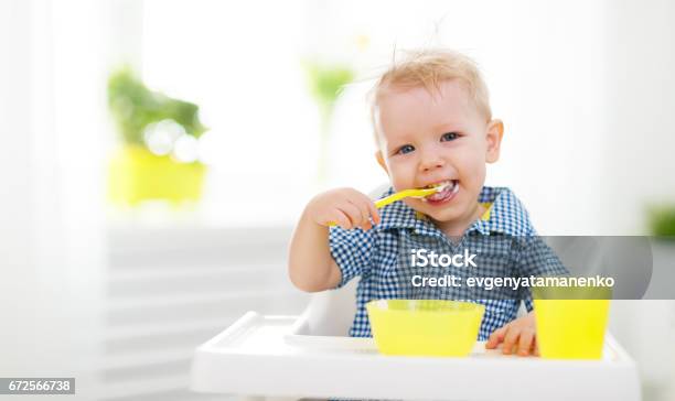 Happy Baby Eating Himself Stock Photo - Download Image Now - Eating, Baby - Human Age, Spoon