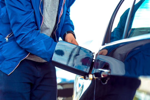 istock Man by his car, preparing to full his fuel tank 672569014