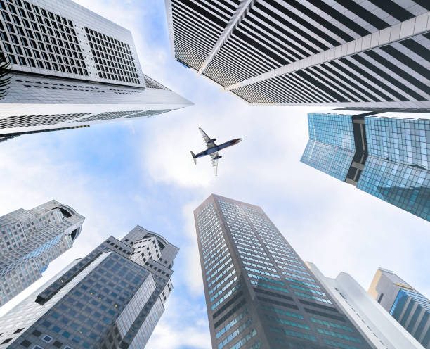 istock Business towers and aircraft 672574836