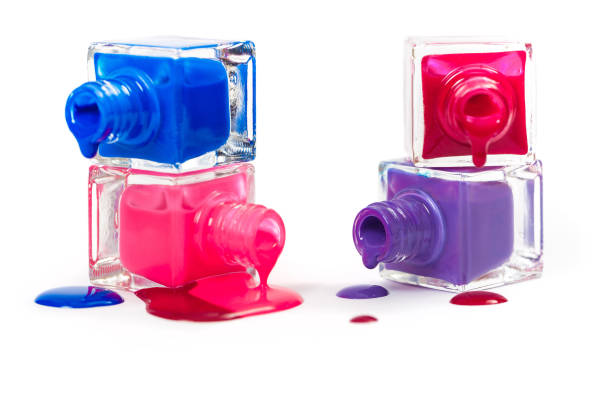 istock Stack of pink and blue nail polish isolated on white background 672575548