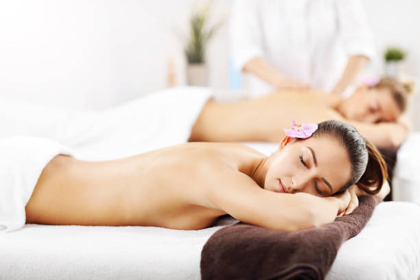istock Two beautiful women getting massage in spa 672575696