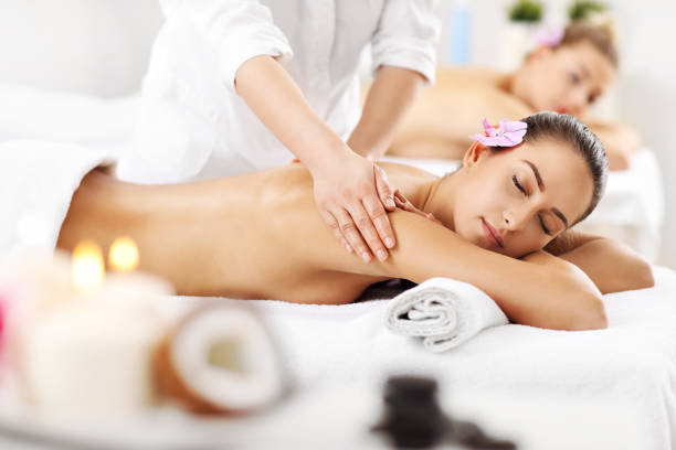 istock Two beautiful women getting massage in spa 672576024