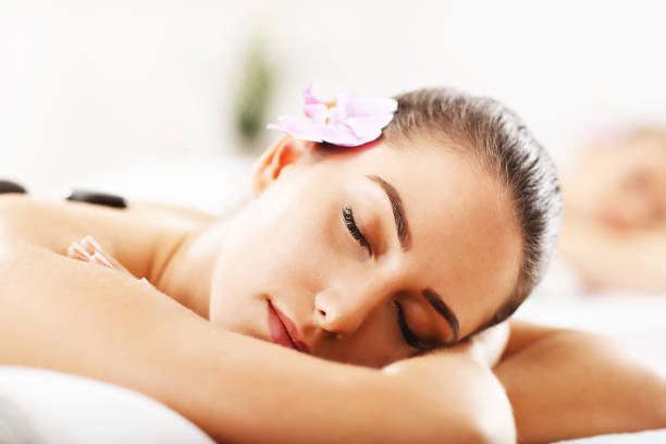 istock Two beautiful women getting massage in spa 672577020