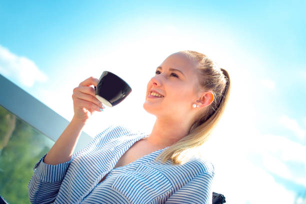 istock Smiling woman with a cup of coffee 672579776