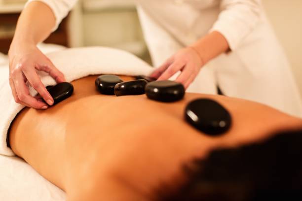 istock Hot stone massage in spa salon 672585800