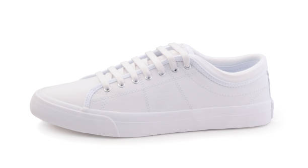 istock Female white sneakers isolated on white 672589500