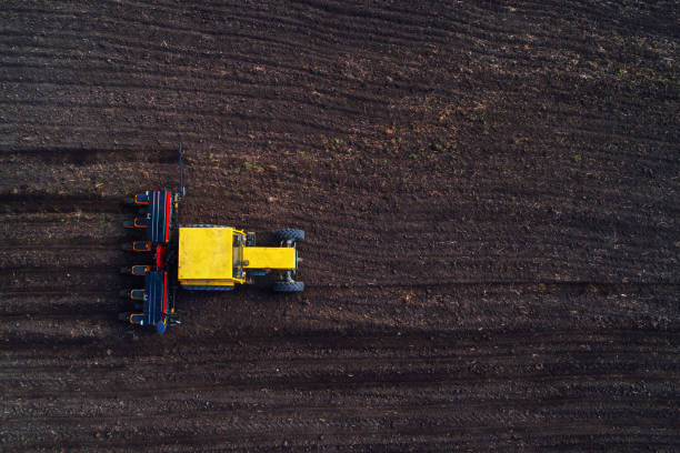 istock Aerial view over tractor working on the harvest field 672589964
