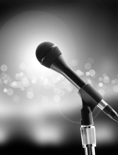 istock Microphone on stage against a background of auditorium 672593798