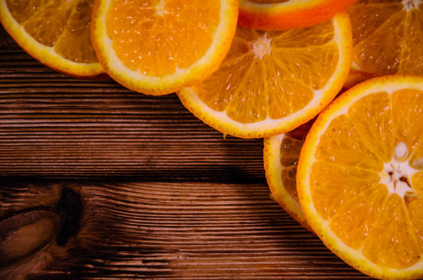 istock Orange slices on wooden table. Top view 672594200