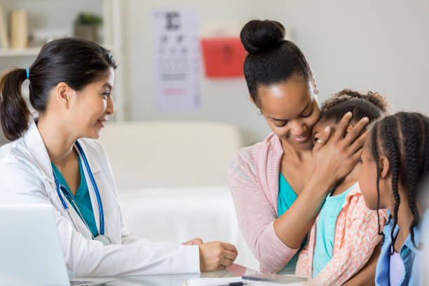 istock Physician prepares to examine sick child 672596858