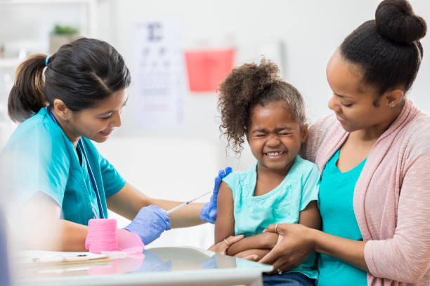 istock Girl makes a face while receiving immunizaiton 672596876