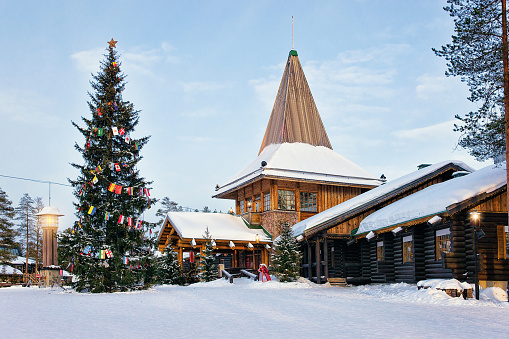 Santa Claus Office in Santa Village with Christmas tree, Lapland, Finland, on Arctic Circle in winter. People on the background