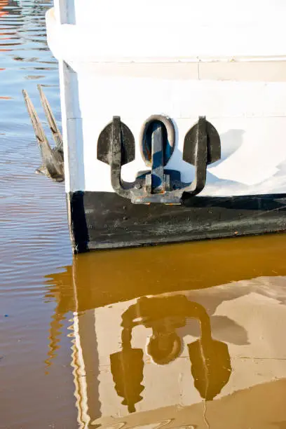 Photo of Ship's bow anchor with reflection