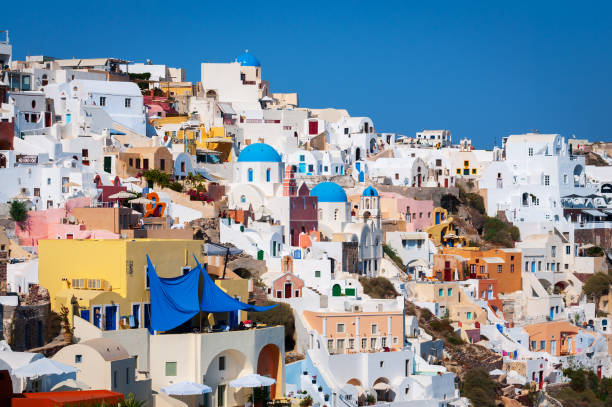 istock Traditional white architecture with blue churches on Santorini island, Greece 672609028