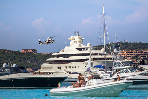 Luxury sailing and motor yachts at Porto Massimo bay at Sardinia Island, Italy
