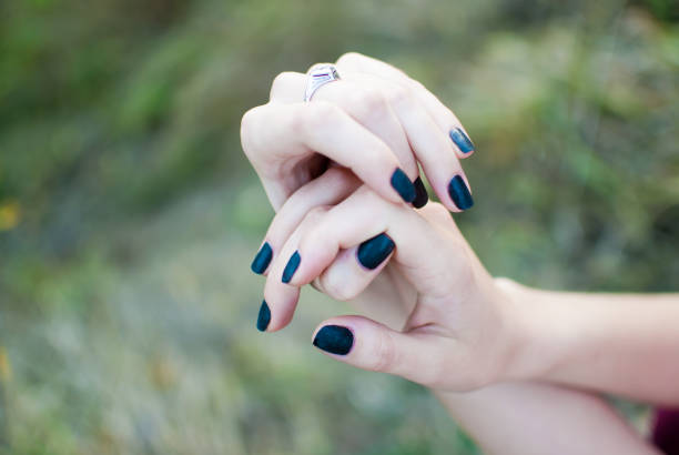 istock Girl's soft and tender beautiful hands. Grass on the background 672617566