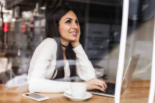 istock Woman in love drinks coffee and chat on laptop computer 672617784