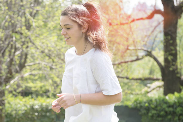 istock Woman jogging in park 672622894