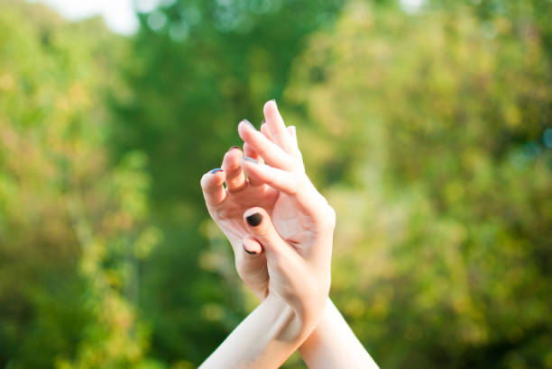 istock Girl's soft and tender beautiful hands and forest 672622928