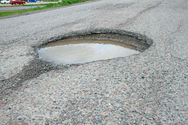 istock Pothole On A Road, Resulting In Hazardous Driving Conditions 672627324