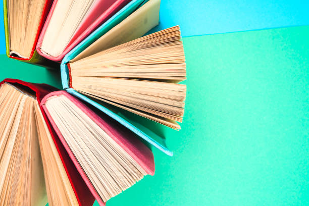 istock Top view of bright colorful hardback books in a circle. 672627640