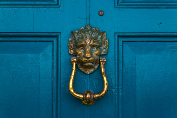 istock Brass lion head knocker, knocker on blue wooden door, decorative element 672637678