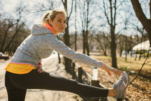 istock Mid adult woman streching after training 672644232