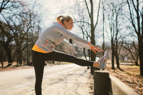 istock Mid adult woman streching after training 672644498