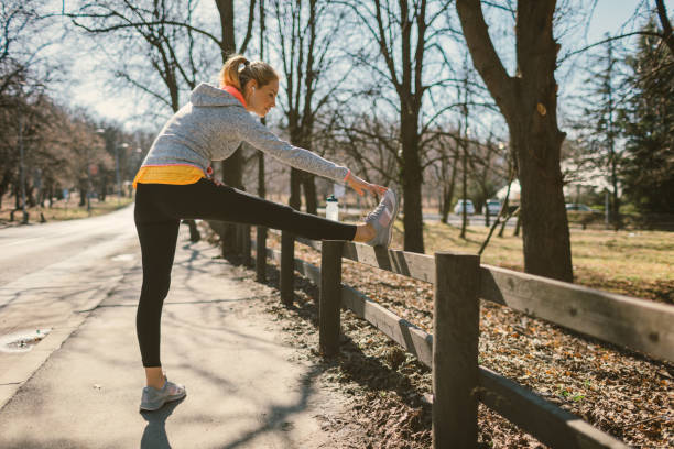 istock Mid adult woman streching after training 672646724