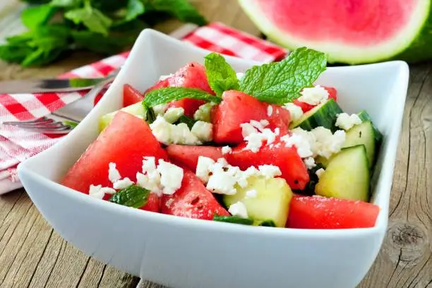 Photo of Watermelon, cucumber and feta cheese salad, close up