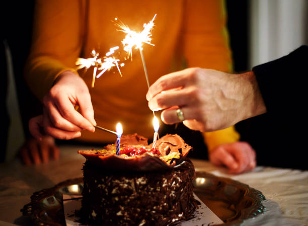 istock Birthday Cake With Lit Candles 672654060