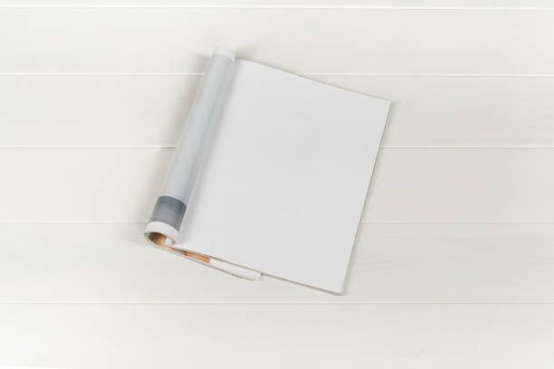 istock Mock-up magazines or catalog on white wooden table background. 672660466