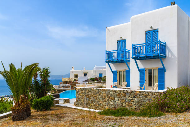 istock Typical white house with blue windows and balconies on Mykonos island, Greece 672664592