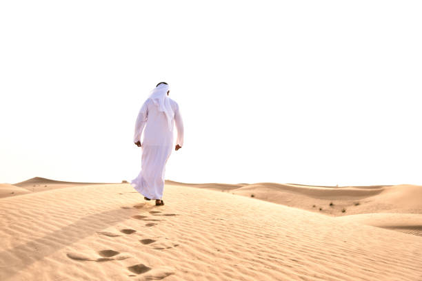 istock arabic man praying in the desert 672665058