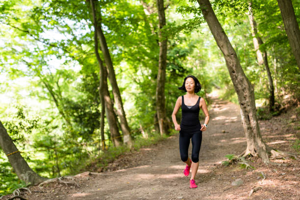 istock japanese woman running in the forest 672670774