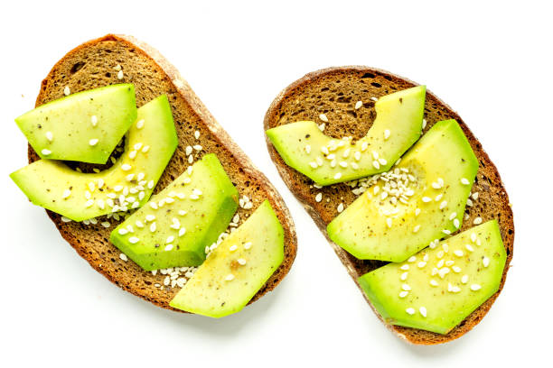 istock Ingredients for cooking sandwiches with avocado on kitchen table top view 672680506