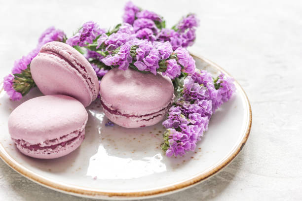 istock Trendy woman pattern with spring flowers and macaroons on plate 672680626
