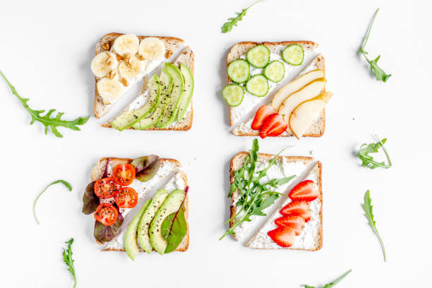 istock healthy breakfast with sandwiches set on white background top view 672681792
