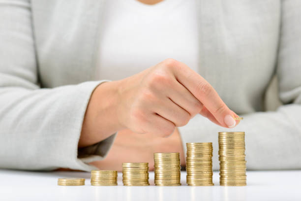 istock Female hand putting money coin stack growing business, saving money concept. 672682204