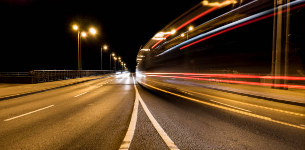 istock Motion blurred traffic in a road curve at night 672685496