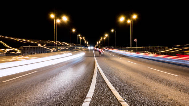 istock Motion blurred traffic in a road curve at night 672685558