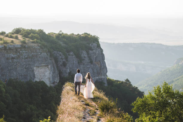 Wedding couple walking in the mountains with stunning views