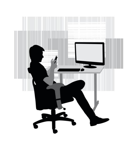 Desk Distractions A vector silhouette illustration of a young man sitting at his desk on a desk chair using his smart phone with a computer on the desk. computer silhouettes stock illustrations